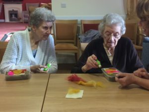 two female residents at Wessex House Care setting participating in a needlefelt workshop