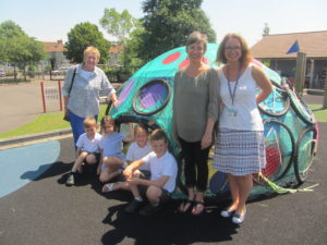 Youth arts co-ordinator from the Art society, school pupils, Nina Gronw-Lewis of ACEarts and Class teacher with pupil designed and built 'podule'.